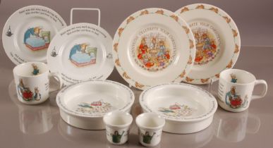Ten modern Wedgwood pottery Peter Rabbit items, including two egg cups, feeding bowls, mugs, and two
