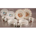 Ten modern Wedgwood pottery Peter Rabbit items, including two egg cups, feeding bowls, mugs, and two