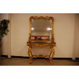 A second half 20th century gilt console table and mirror, the rococo style ornate base with shaped