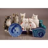 A group of seven modern pottery pussy cats, including an example from Poole, Beswick, Sidmouth and