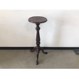 An early 20th century mahogany plant stand, 93cm high, on carved tripod base