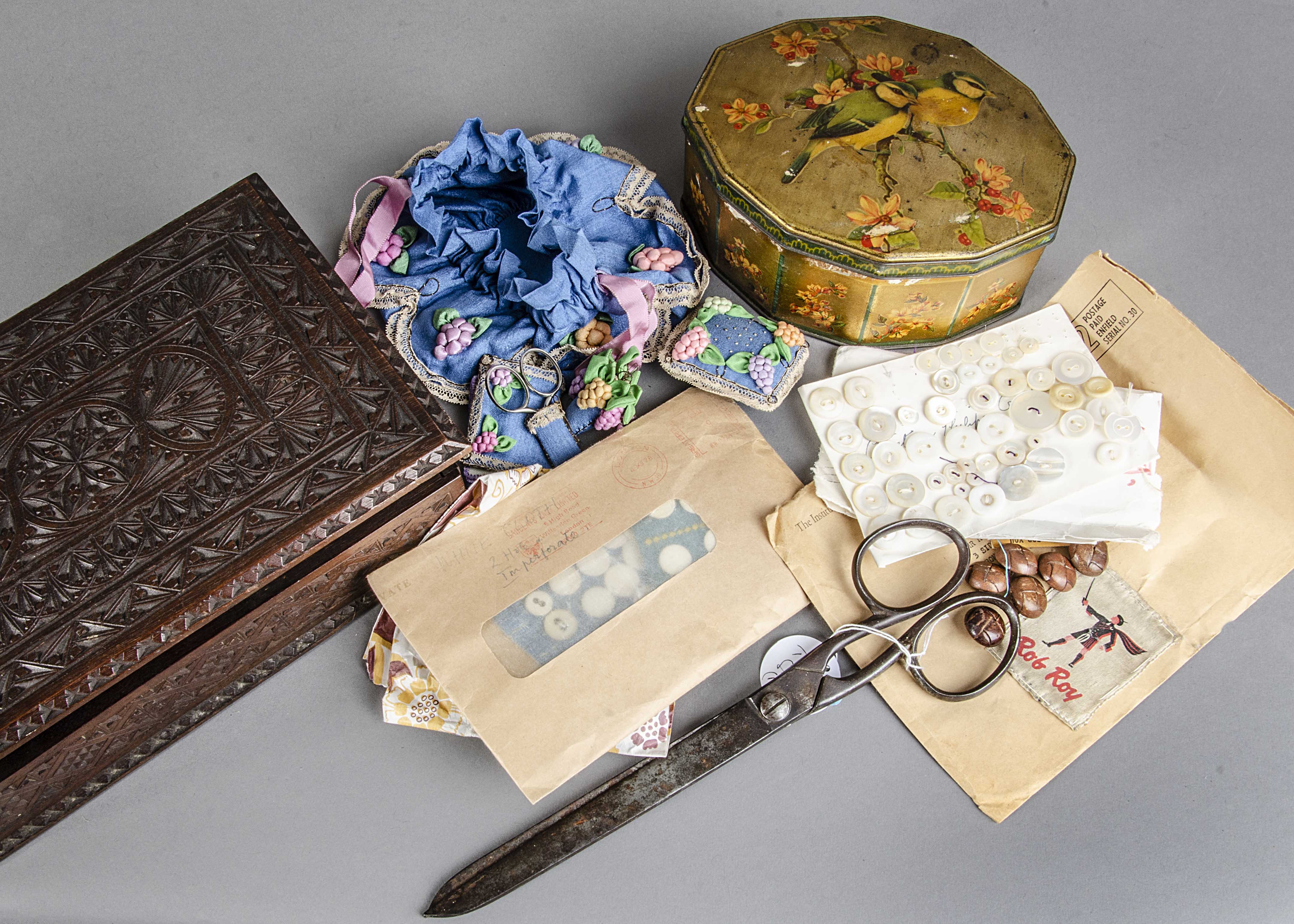 A collection of buttons, gloves and textiles, first half 20th century, the buttons in a wooden