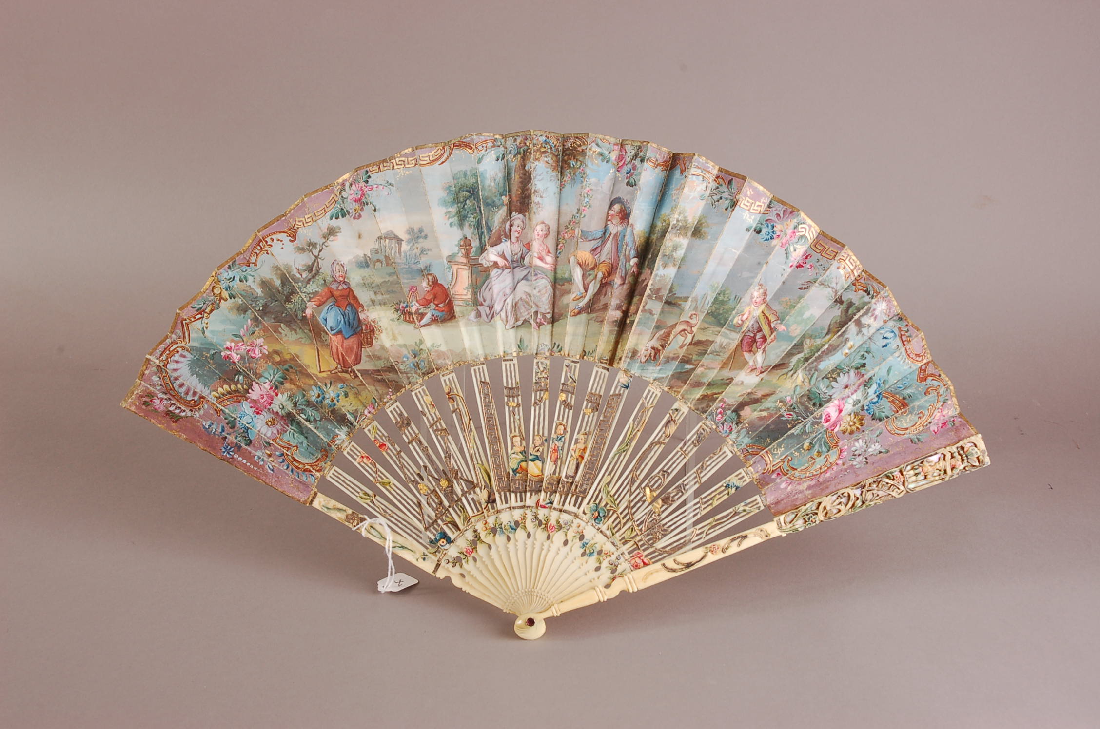 A nice 18th century French carved ivory and paper leaf fan, 27cm, finely pierced sticks with figures