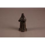 A late 19th century bronze figure of a priest, 13.5cm high, stamped HOCHMUT or similar, appears to
