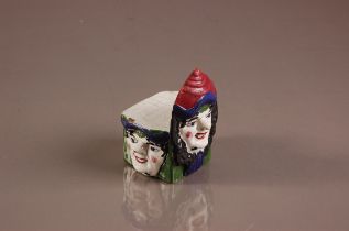 A Victorian Staffordshire pottery novelty sash window stop, 11.5cm, having three faces to square