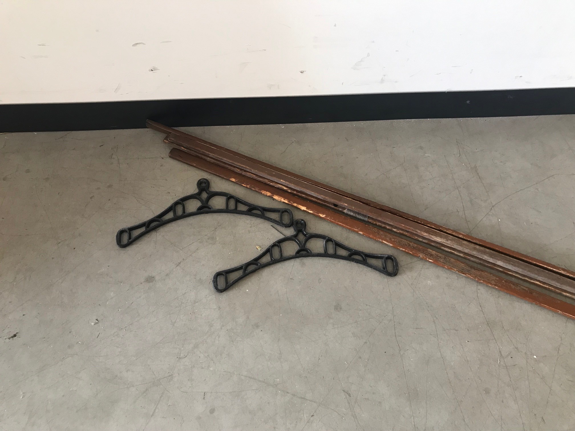 An Edwardian clothes drying rack, two black painted metal ends with four batons of wood