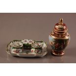 An early 20th century Dresden porcelain inkwell stand, 24cm, with twin inkwells and smalled box,