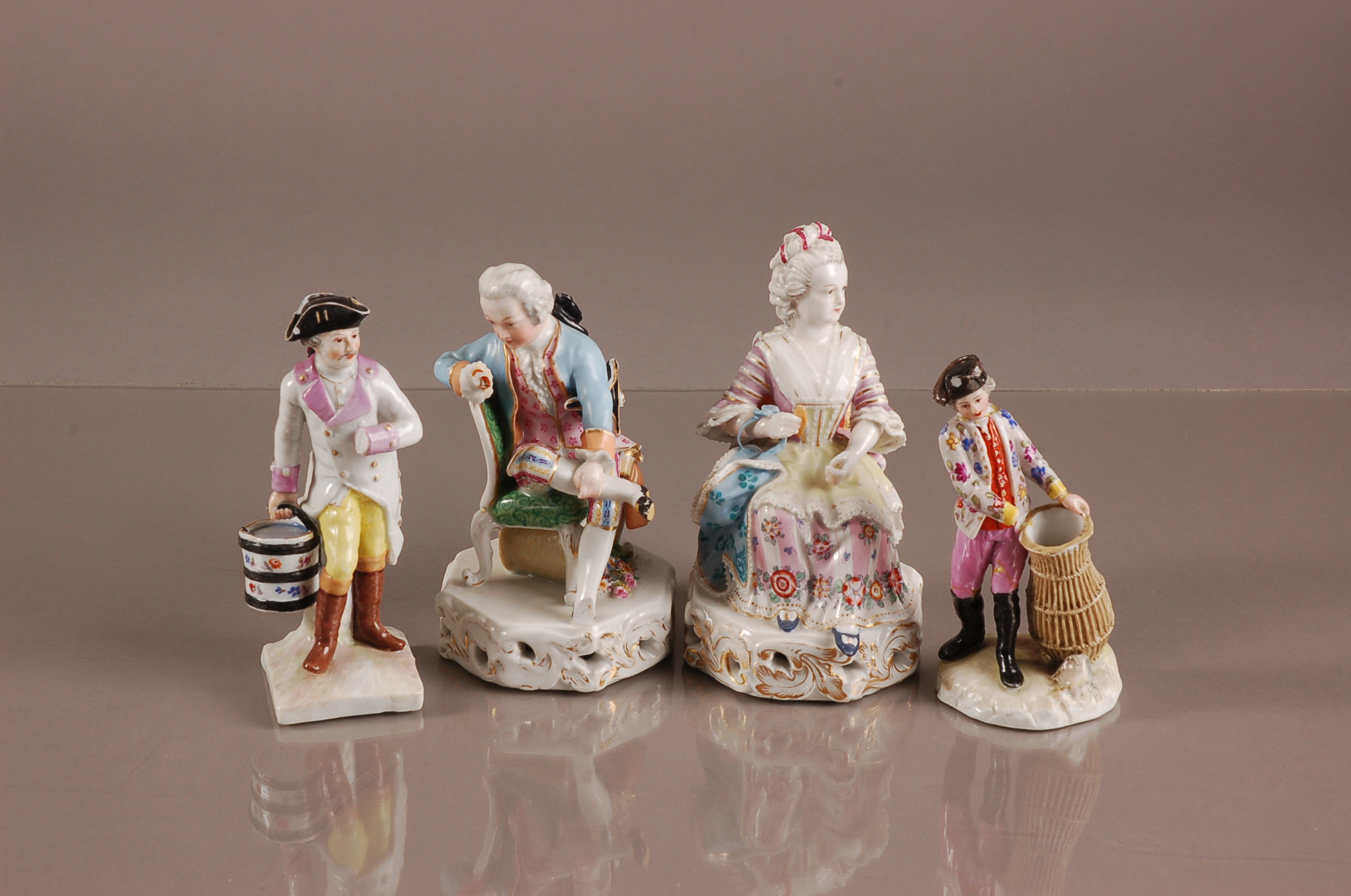 Four 19th century German porcleain figures, AF, including a lady and a gentleman sat on chairs, a