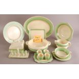 An Art Deco period Newport Pottery and Royal Staffordshire part dinner service by Clarice Cliff,