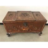 A c1950s Chinese camfour wood chest, 106cm wide, AF, with vignette of carved landscape scenes with