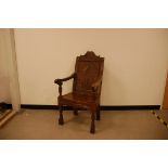 A 17th century joined hall chair, AF, with carved back and friezes, some repairs and damages,