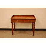 A Victorian mahogany washstand or writing table, four turned supports with two drawers, 91cm
