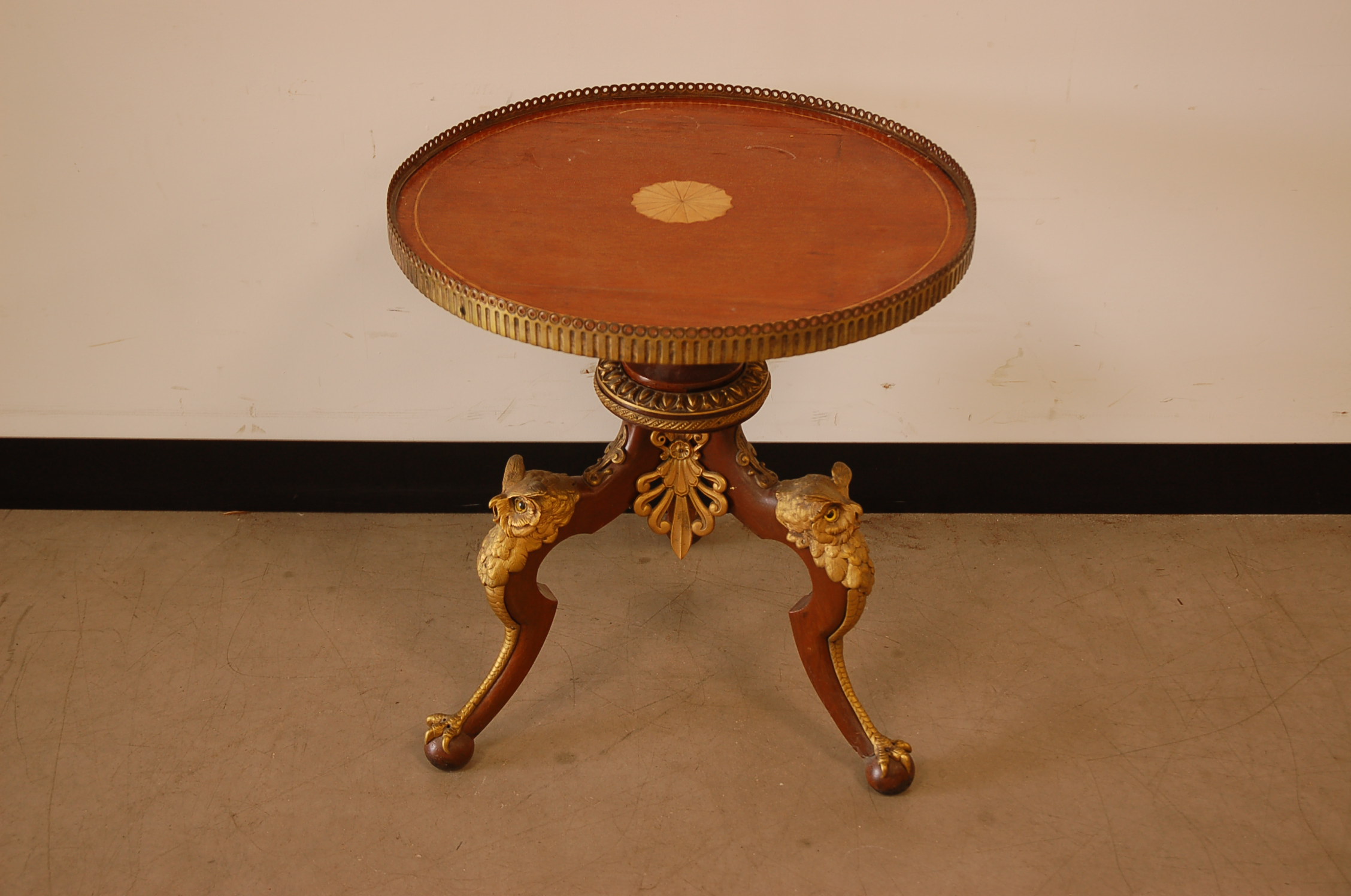A mid 20th century mahogany and gilt occasional table, nicely mounted with gilt metal owls heads