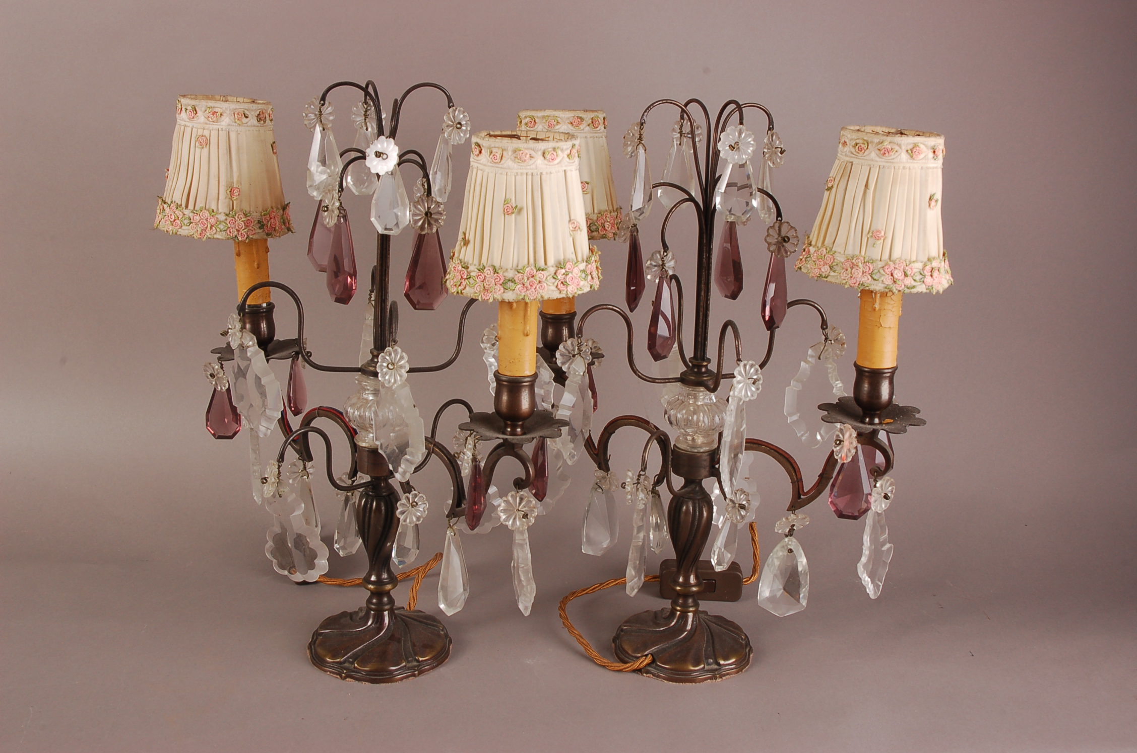 A pair of first hlaf 20th century lamp bases, two branch with applied glass lustres and pendants,