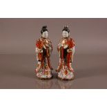 A pair of damaged Japanese Kutani style porcelain figural candlesholders, 29cm, modelled as young