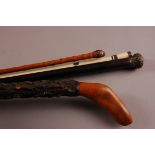 Two Victorian walking canes and a swagger stick and a walking stick, including a bone cane, an