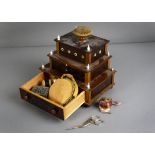 A wooden sewing box, mid 19th century composed of three tiers, the top with pin cushion ferrule, the
