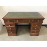 A c1970s walnut veneered pedastal desk, 123cm wide, with green leathrette inset top