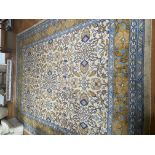 A large vintage Middle Eastern woollen carpet, in cream, white and blue, some wear