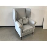 A first half 20th century wing back armchair, in grey upholstery, AF