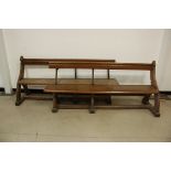 Two Victorian oak and wrought iron pews, on ogee arch supports, 181cm and 183cm, probably once a