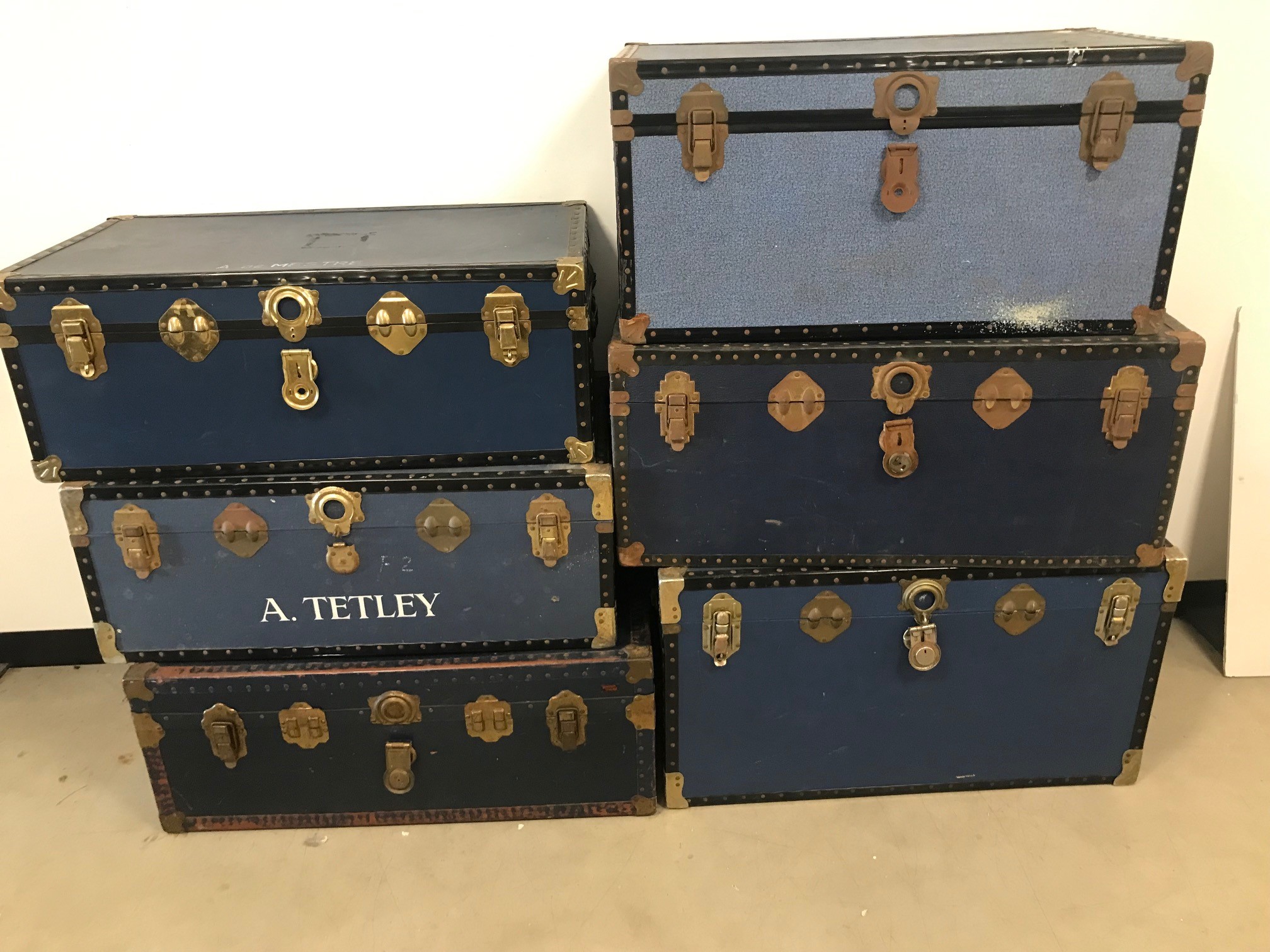 Six vintage travel trunks