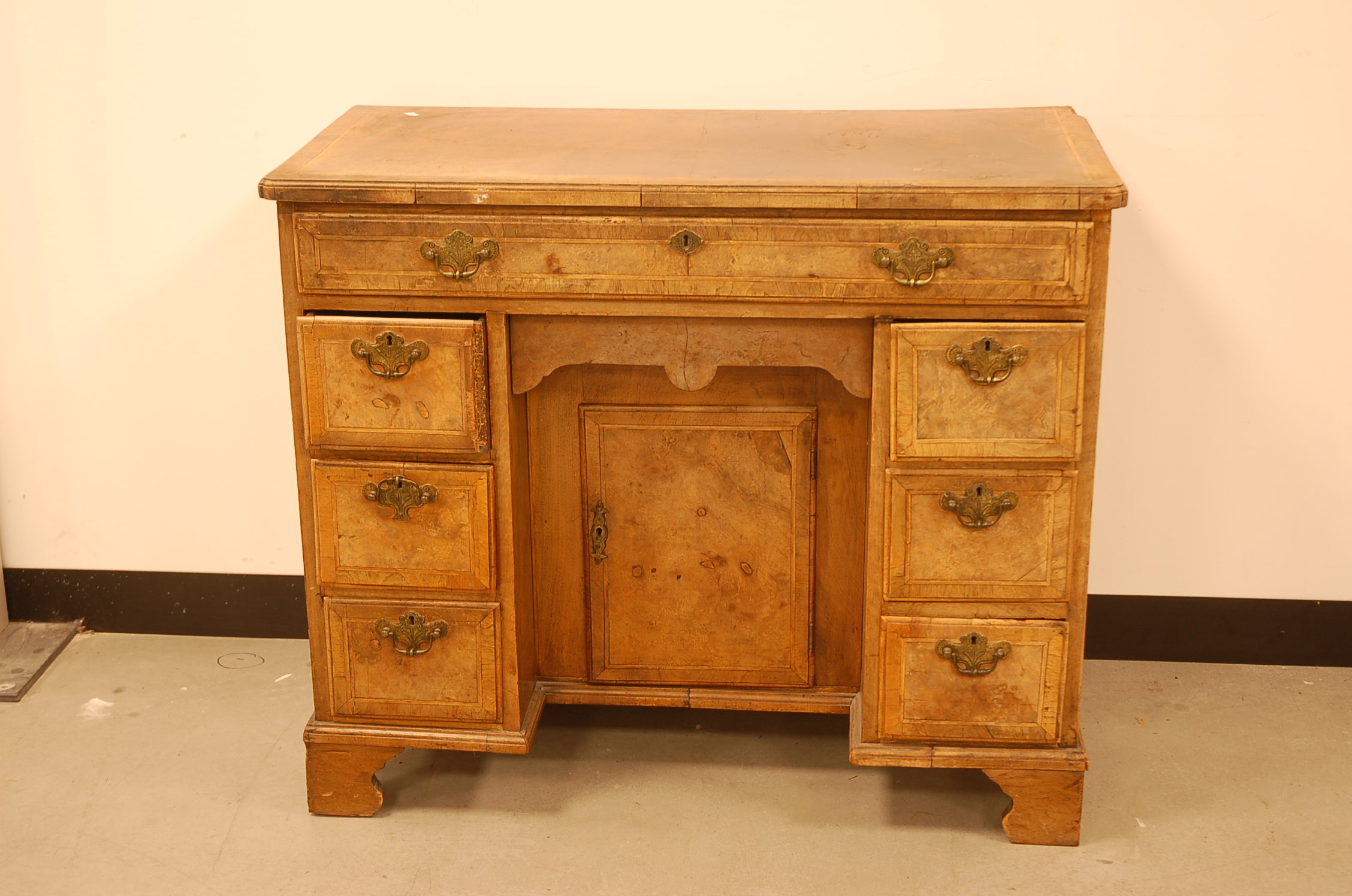 An 18th century walnut and inlaid kneehole desk, 90cm wide, AF, heavily faded