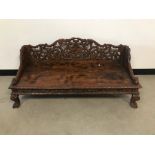 A second half 20th century Indian carved wood low bench, 126cm wide