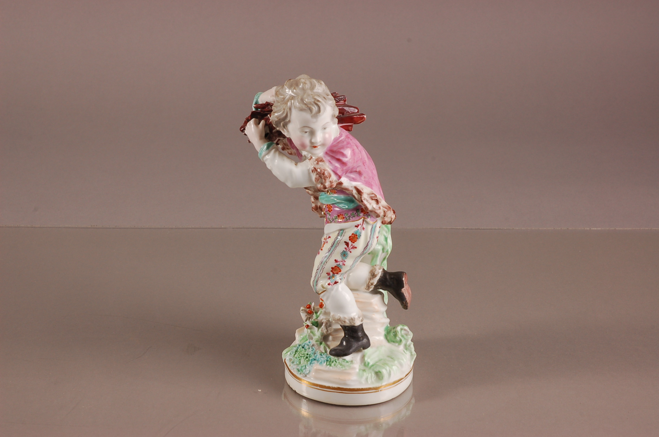 A 19th century British porcelain figure of a young woodsman, proabably Derby, modelled walking