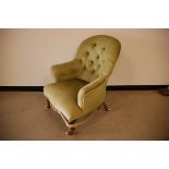 A Victorian and later armchair, turned front supports and sabre back legs on porcelain casters, with