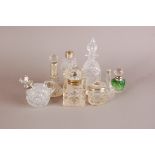 A small group of cut glass items, including an ink well, a scent bottle and stopper with silver