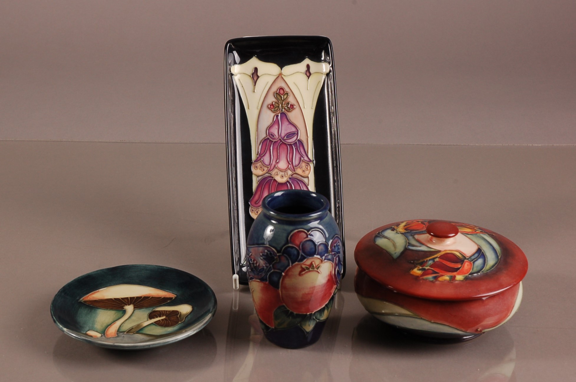 Four second half 20th century Moorcroft pottery items, including a circular box and cover, a small