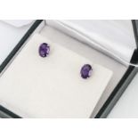 A pair of silver and amethyst ear studs