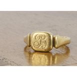 An 18ct gold signet ring, with cushion shaped tablet, on tapered hallmarked shank, Birmingham