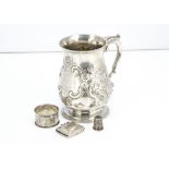 A 19th Century white metal tankard, with raised floral decoration and having inscription dating to