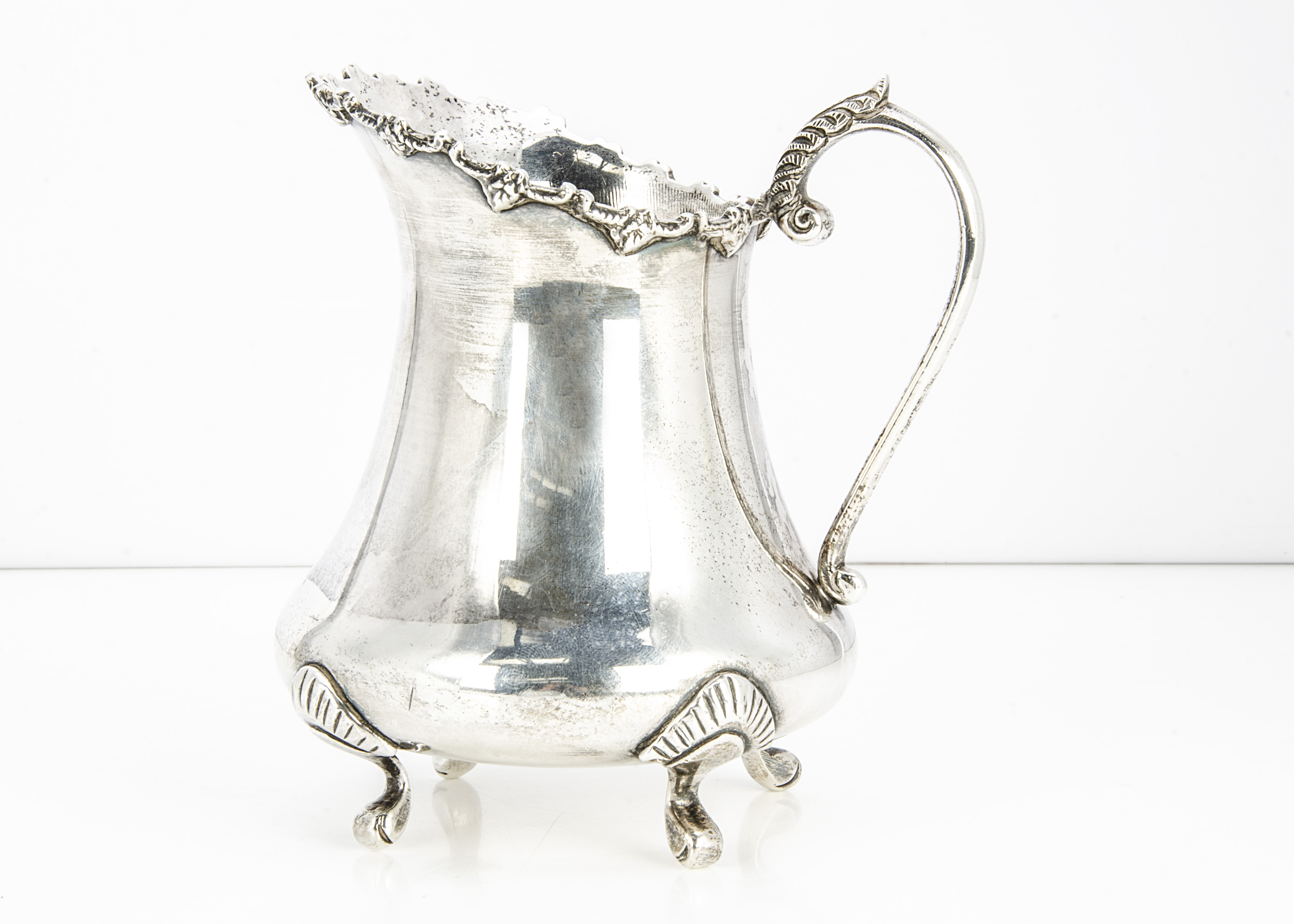 A c1970s Indian silver milk jug, 11 ozt, 12.5cm high, bearing import hallmarks from the London Assay - Image 2 of 2