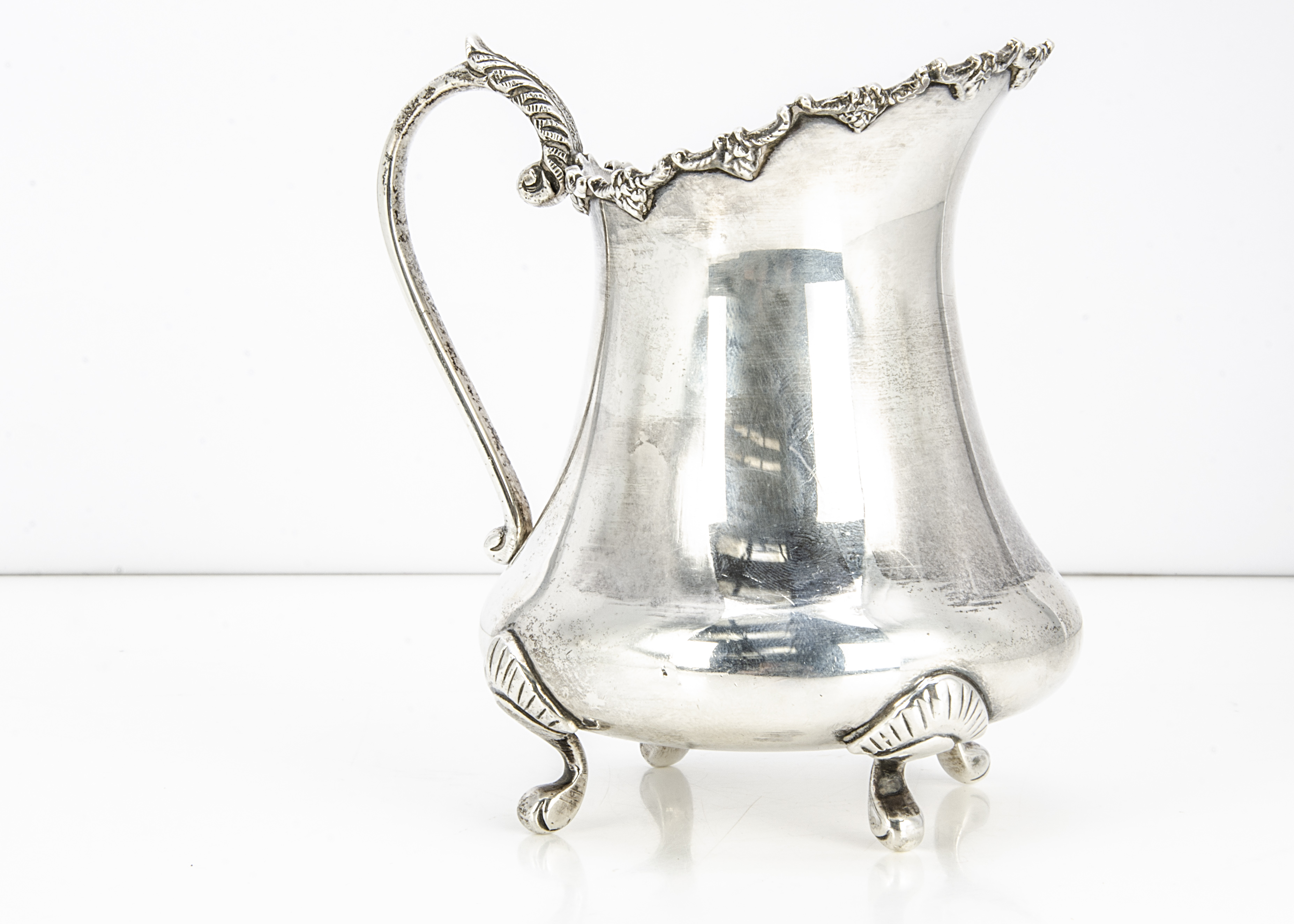 A c1970s Indian silver milk jug, 11 ozt, 12.5cm high, bearing import hallmarks from the London Assay