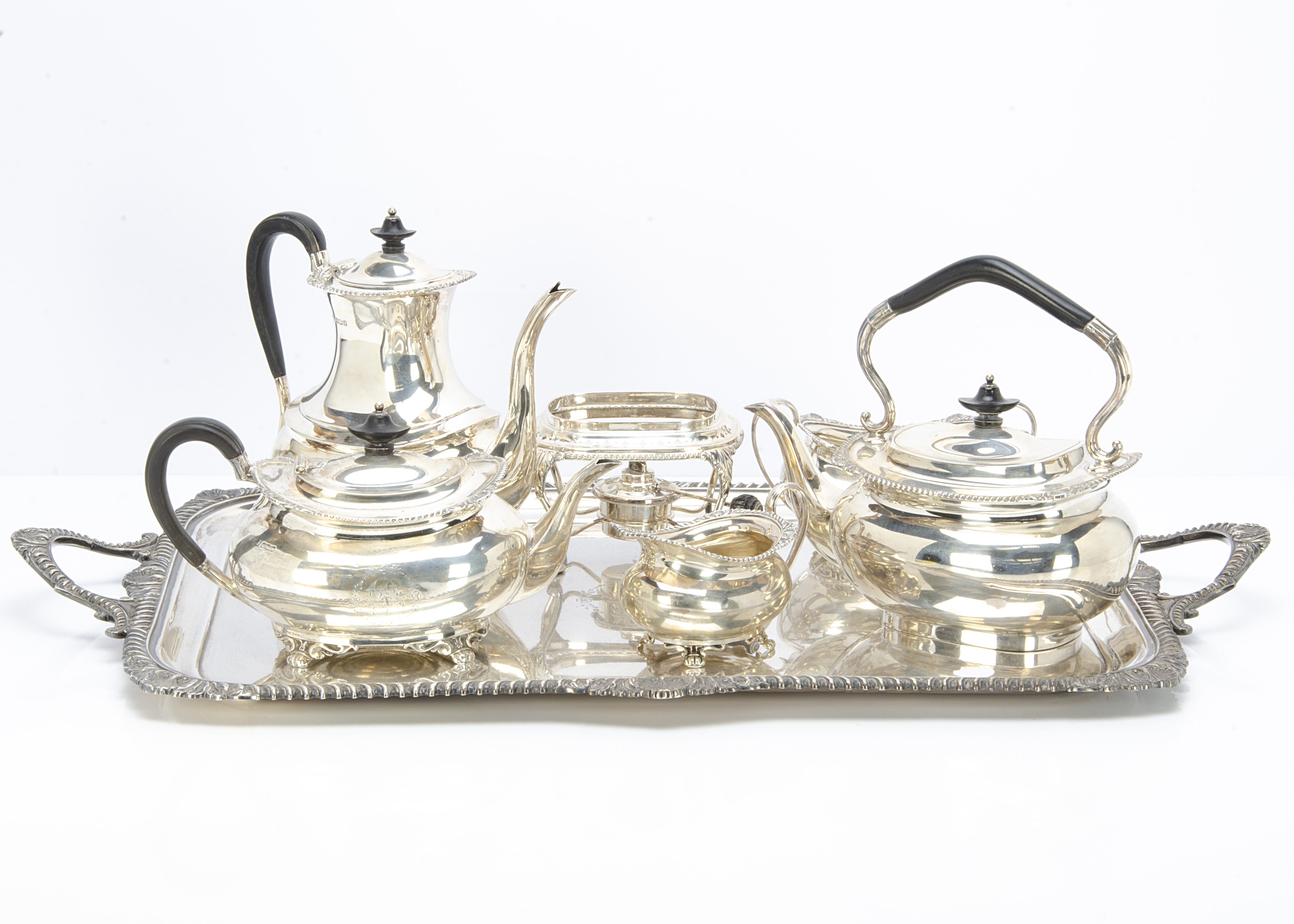 A good George V silver tea set and tray by HA, retailed by Spiridion & Son Cardiff, having feathered