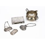 Five items of silver, including a twin lipped circular jug, a matchbox holder, a pair of decanter