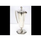 A 1960s silver ecclesiastical claret jug, by B & W, tapered body with handle, hinged cover with