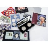 A collection of modern uncirculated coins, including a Millennium £5 and Britannia Bullion £2 set,