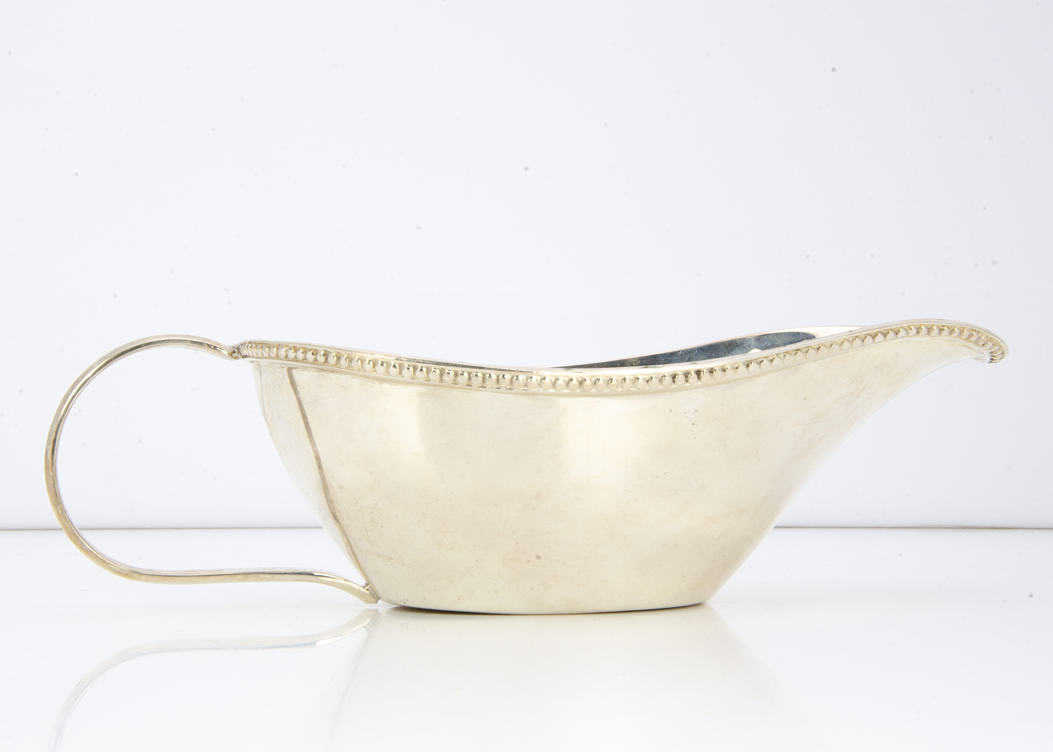 A c1970s century Egyptian white metal sauce boat, 4.97 ozt, with bead rim and loop handle, three