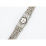 A c1980s Accurist 9ct white gold lady's wristwatch, 11mm wide, small circular dial in textured