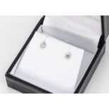A pair of diamond stud earrings, the brilliant cuts in six claw setting, diamonds 0.30ct, 0.5g
