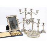 A collection of silver plate and other metal ware, including two candlesticks, a photograph frame,
