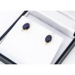 A pair of sapphire and diamond stud earrings, oval mixed cut sapphires in claw settings with small