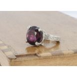 A contemporary rubellite and diamond ornate set dress ring, the circular mixed cut tourmaline with