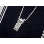 A white 18ct gold diamond set pendant and chain, the pendant set with three rows of princess cut