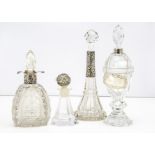 Three Victorian and later cut glass and silver mounted bottles, each with stoppers, together with