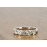 An 18ct white gold five stone diamond dress ring, brilliant cuts in claw settings, ring size M, 0.